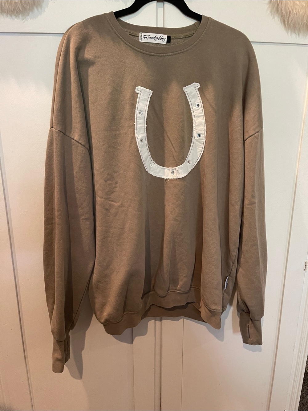 The Laundry Room women’s Crewneck Sweater in Taupe with White horse shoe patch